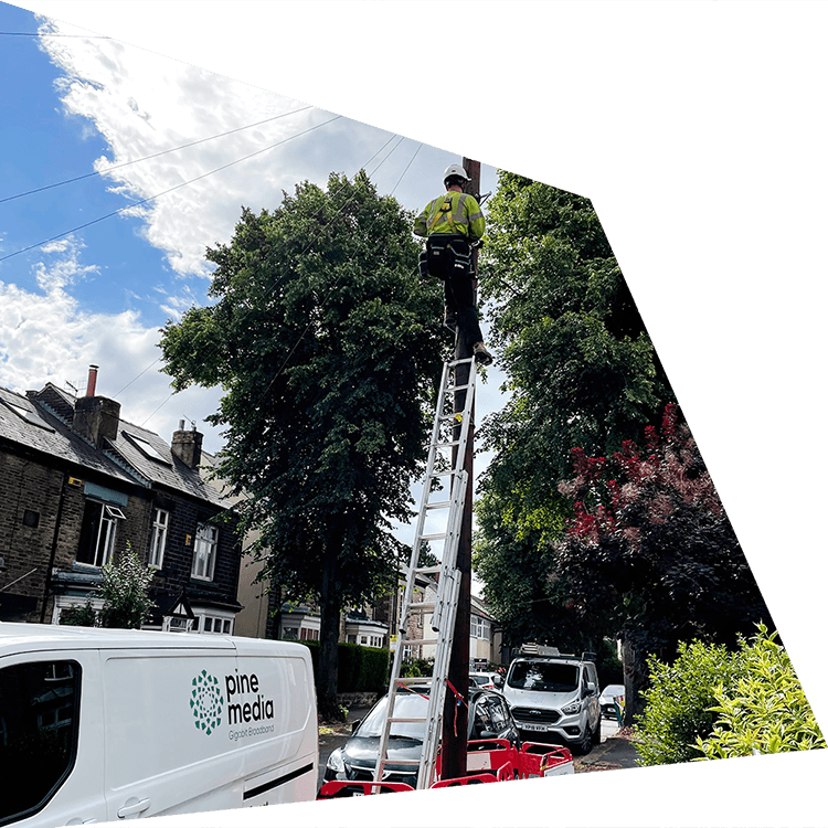 A Pine Media engineer climbing a telegraph pole